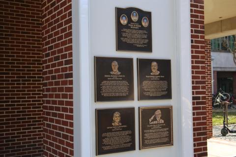 Five brass wall plaques